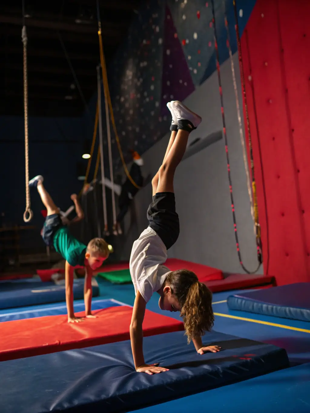 A dynamic image of gymnasts performing acrobatic moves during a community event, showcasing the excitement and energy of ENERGYM's public performances.